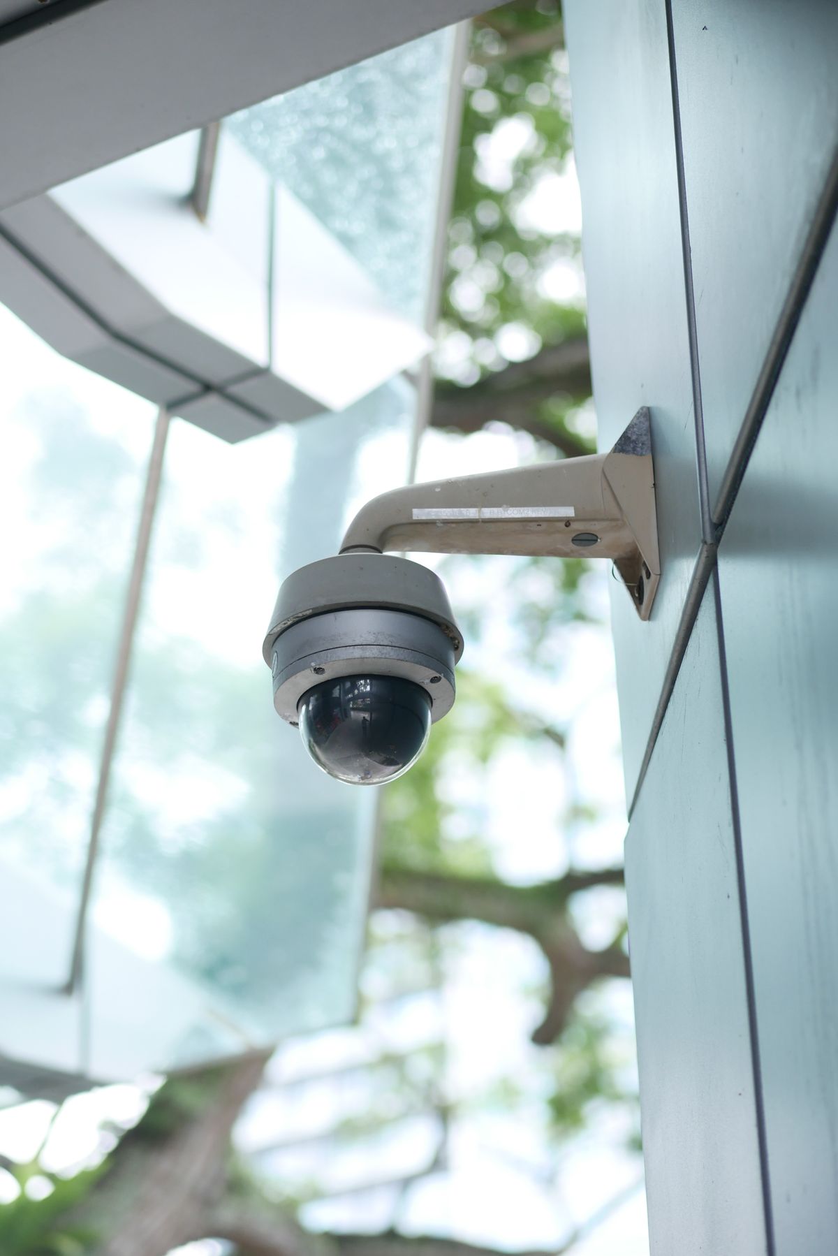 Outdoor security camera mounted on an exterior wall
